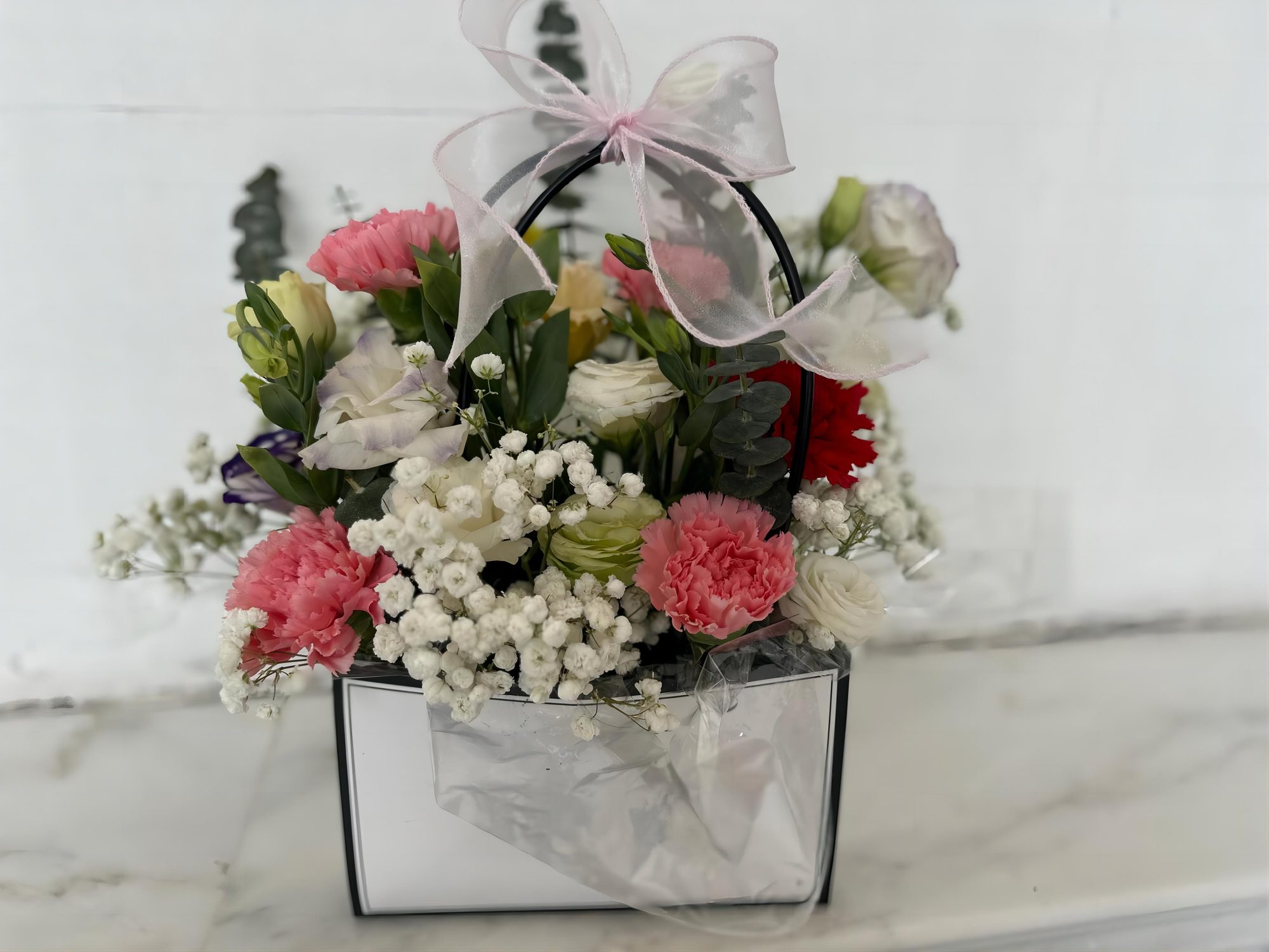 A finished flower arrangement on a marble table