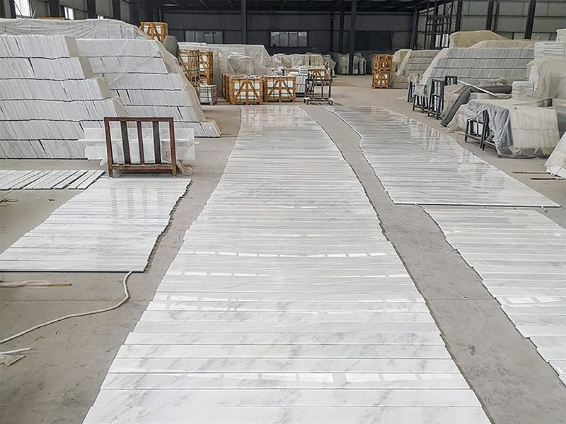 Slabs laid out in rows on the warehouse floor