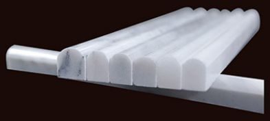 Three white marble moulding profiles laid on a dark background