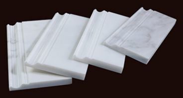 Stacked white marble skirting and moulding pieces